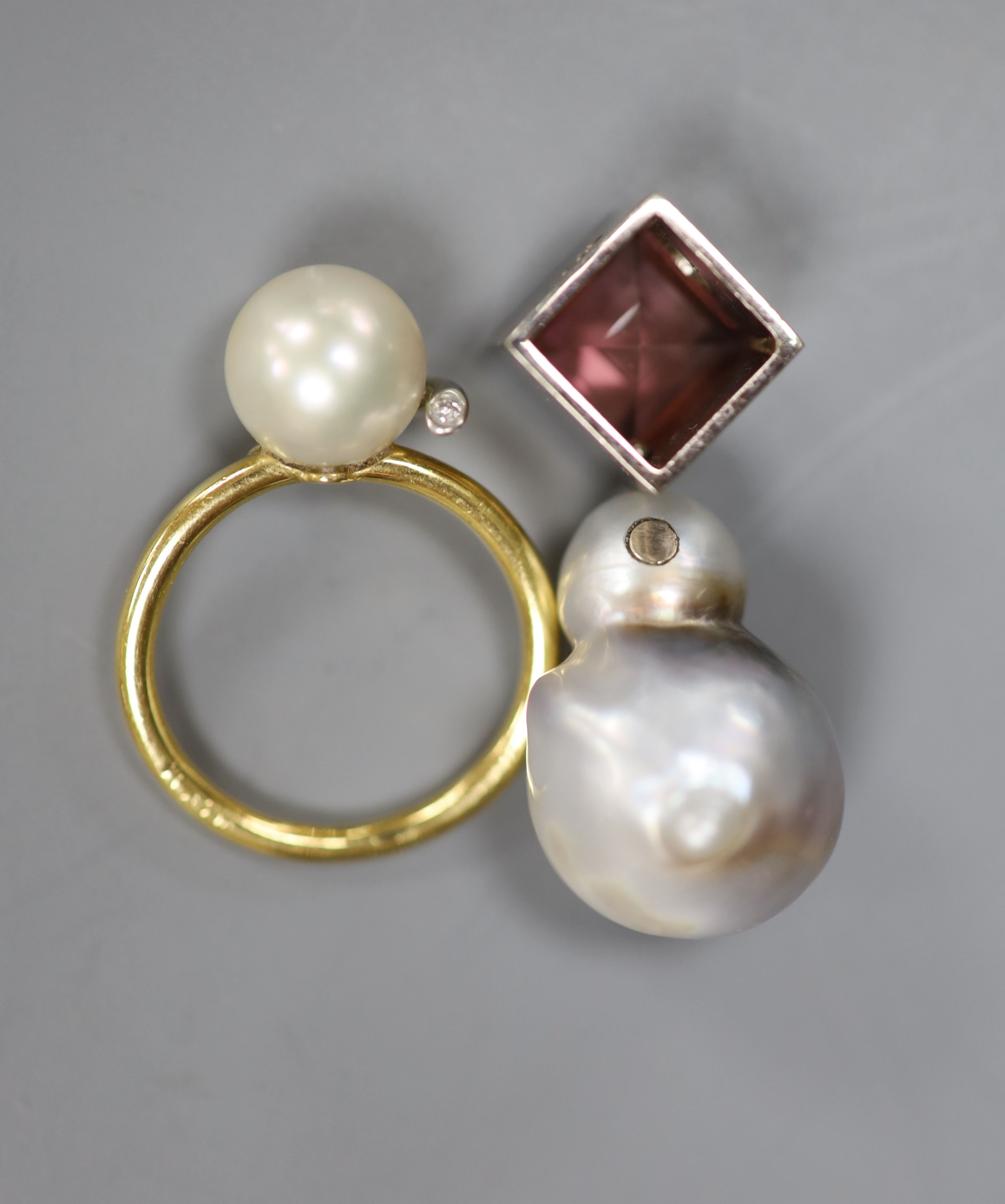 A modern 585 white metal, baroque pearl and pink tourmaline set pendant and a yellow metal cultured pearl and diamond chip set ring